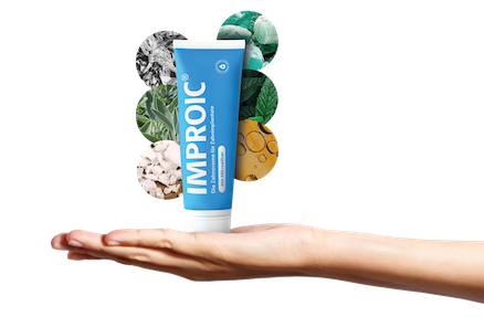 Toothpaste tube standing on a hand